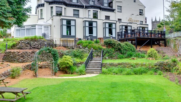 A two-story building with a stone facade and a balcony. - The Anglesey Arms (Menai Bridge)