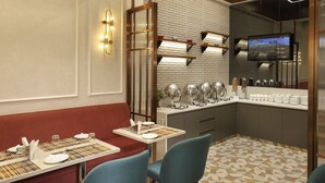 A modern restaurant with a brick wall, a television, and a buffet area. - Indus Biznotel (New Delhi)