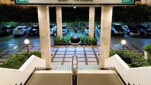 A hotel entrance with a sign reading "BON VOYAGE" and directional signs for Chiang Mai and Bangkok. - The Viangtak Riverside Hotel (Tak)