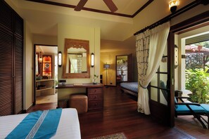 A bedroom with a bed, a desk, a chair, and a window with curtains. - Anavana Beach Resort (Koh Samui)