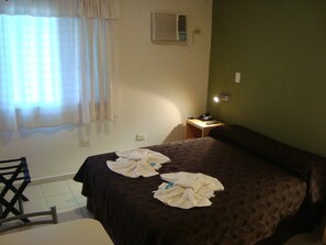 A hotel room with a bed, a bedside table with a phone, a chair, and a window with curtains. - Hotel Siena Buenos Aires (Buenos Aires City)