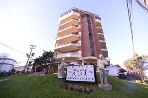 A multi-story building with a sign for 'Chibcha Restaurant' in front. - Tequendama Spa & Resort (Villa Gesell)