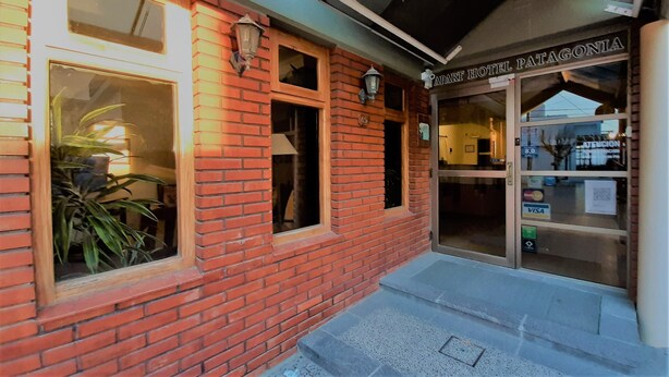 A brick building with a sign reading "APART HOTEL PATAGONIA" and a door with a window. - Patagonia Apart Hotel (Puerto Madryn)