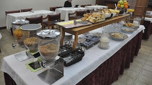 Una mesa de buffet con diversos alimentos y utensilios.