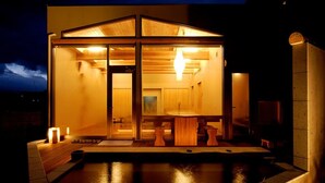 A modern, well-lit wooden structure with a glass door, a small table, and a bench outside. - Hanaisawa (Ryokan) (Fuefuki)