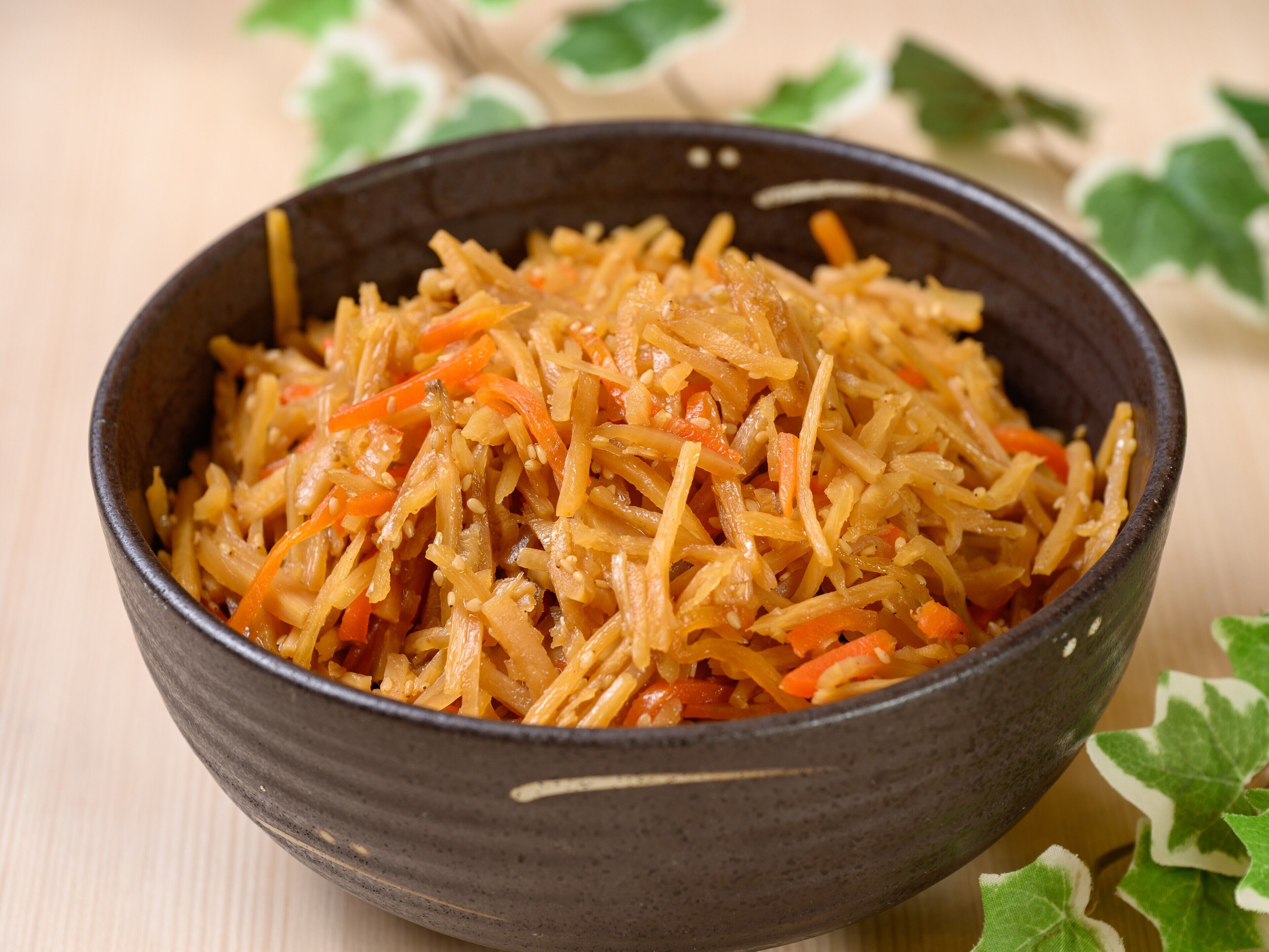 A bowl of shredded vegetables with sesame seeds.