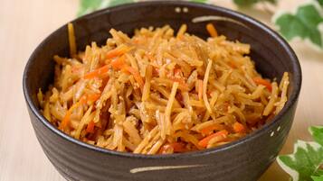 A bowl of shredded vegetables with sesame seeds.