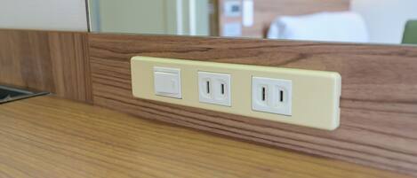 Un panel de madera con tres enchufes eléctricos.