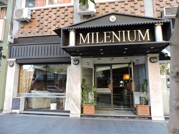 A building entrance with the name 'MILLENIUM' prominently displayed above the door.