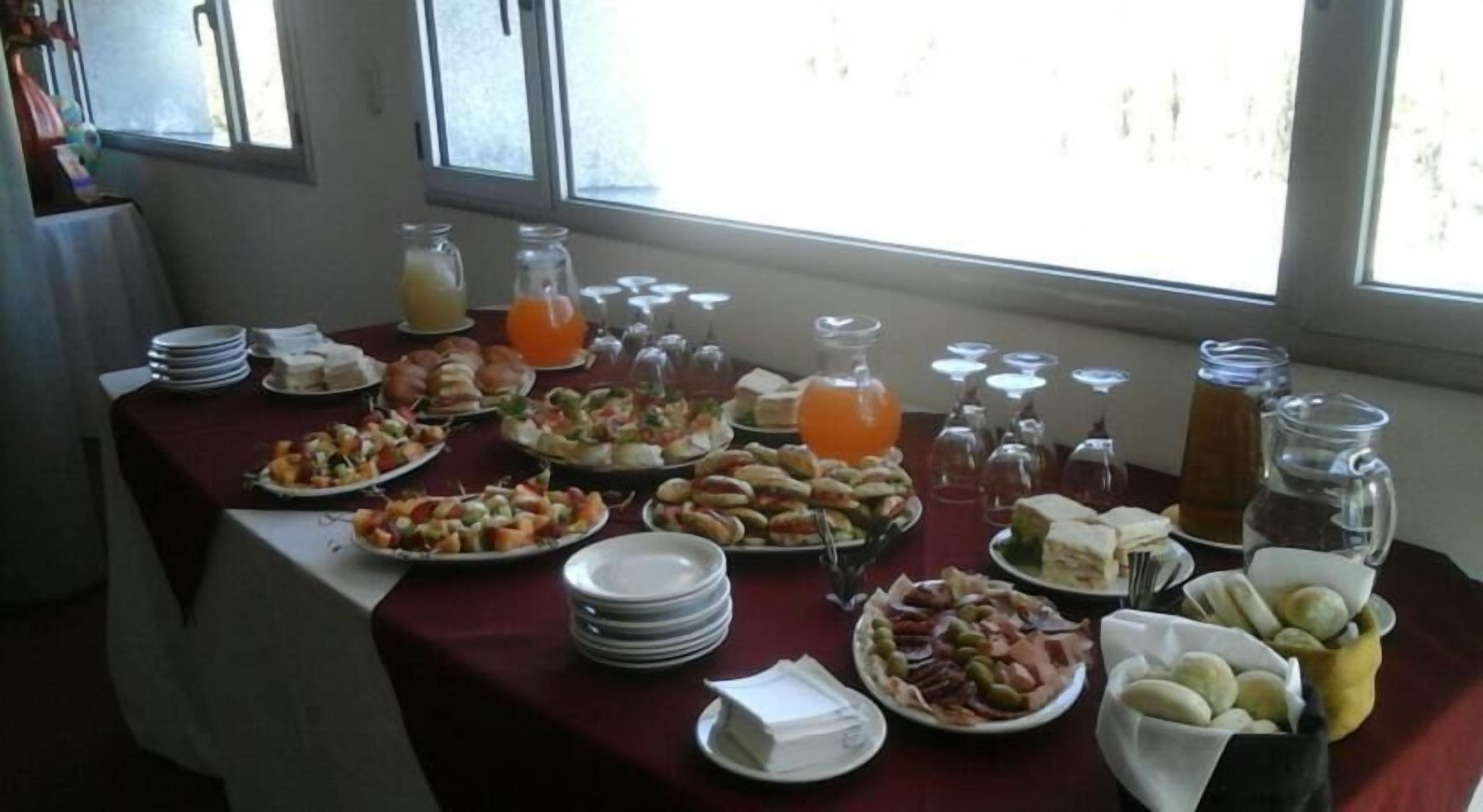 A breakfast buffet with various food items and beverages.