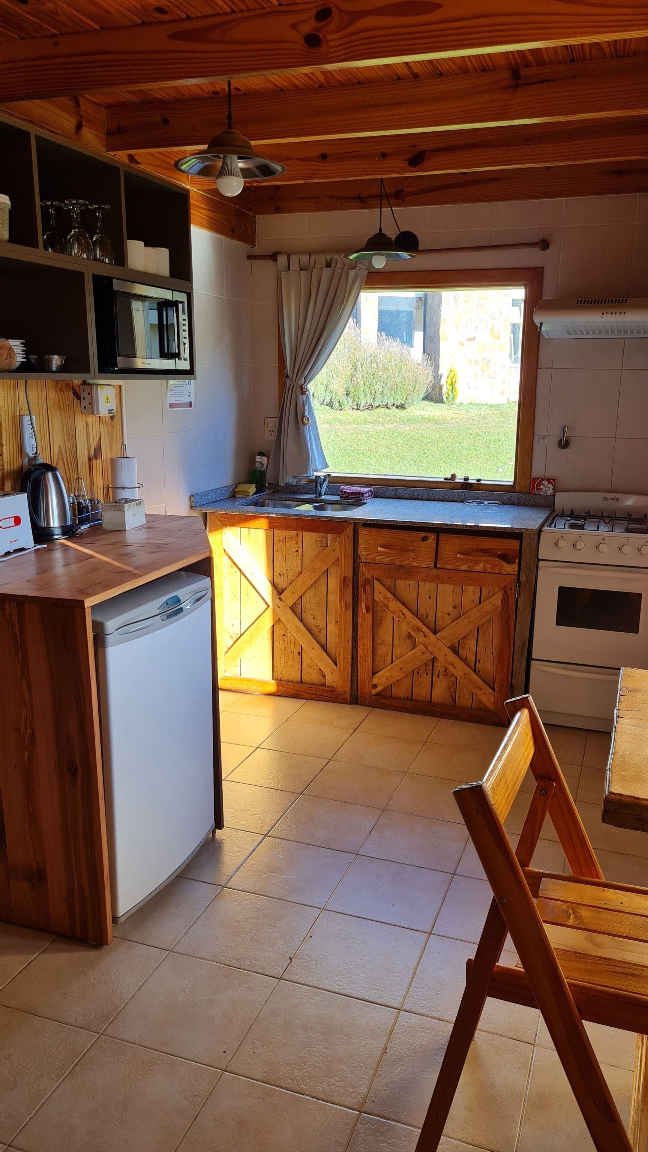 A kitchen with wooden cabinets, a built-in microwave, a gas stove, and a dishwasher.