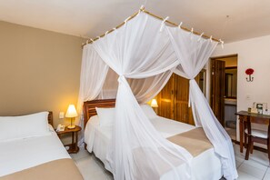Triple Room | Minibar, in-room safe, individually decorated, blackout drapes