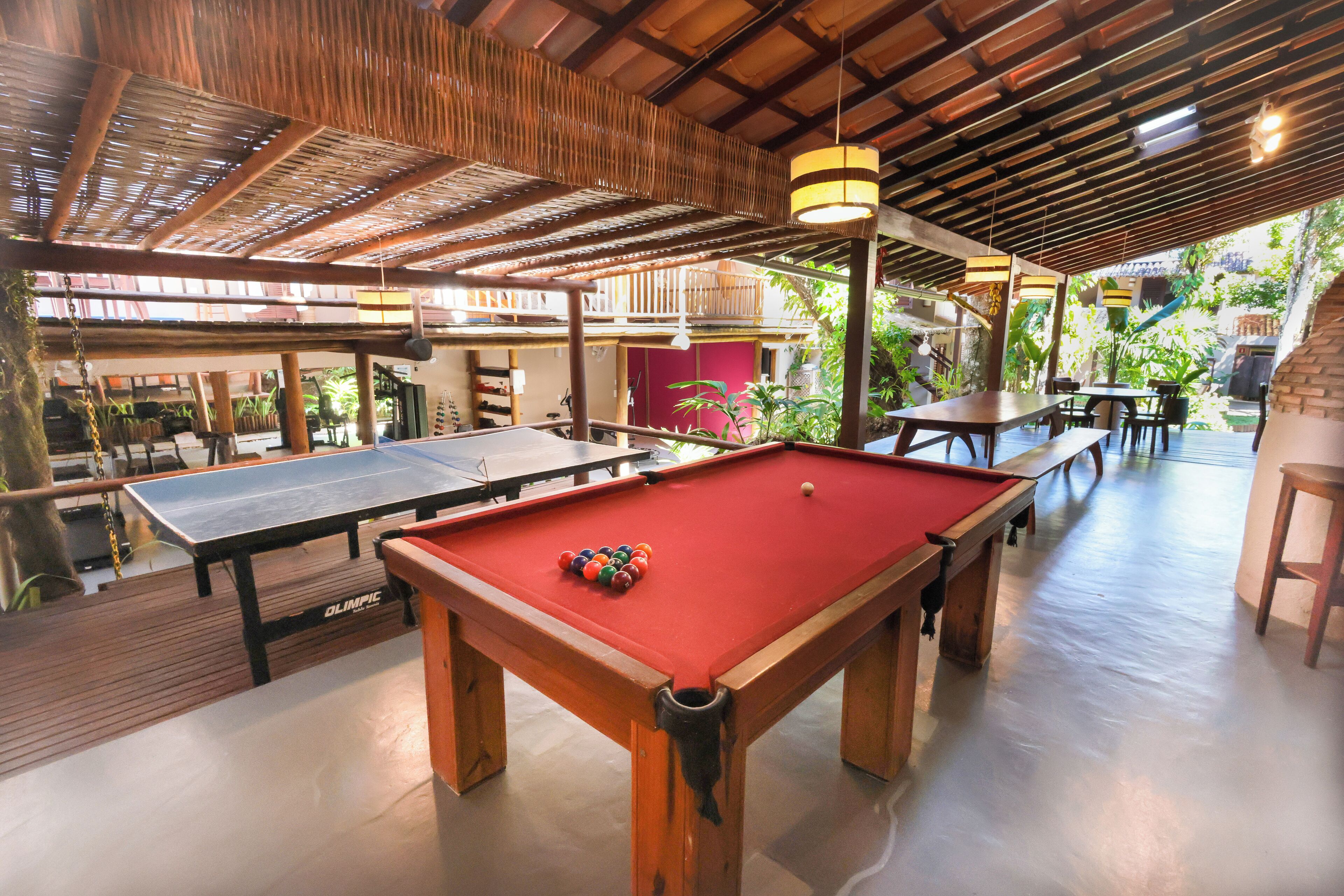 A pool table with balls, a billiard table, and a red pool table cloth.