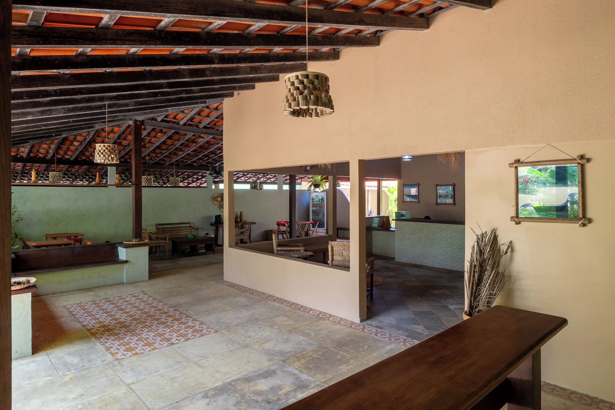 A spacious interior with a high ceiling, a central seating area, and a view of the outdoors.
