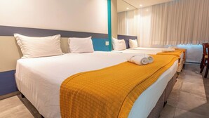 A hotel room with two beds, a large mirror, and a view of the city. - Rede Andrade Navegantes (Recife)