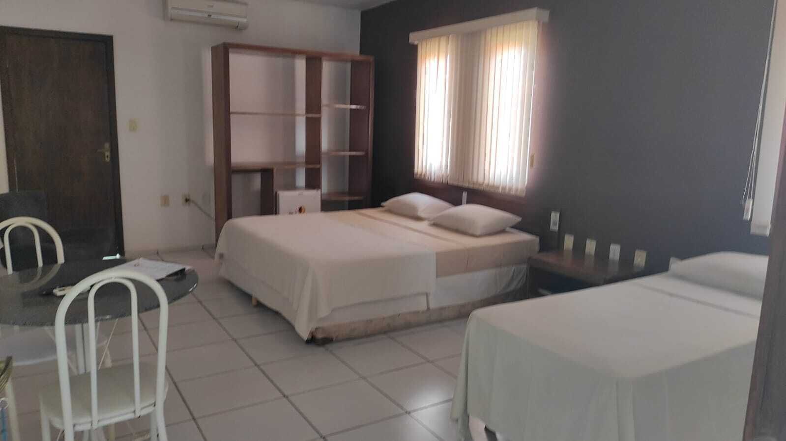 Una habitación con cama, escritorio, silla y armario.
