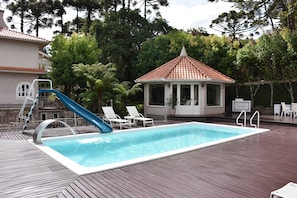 Outdoor pool, open 10:00 AM to 8:00 PM, pool loungers