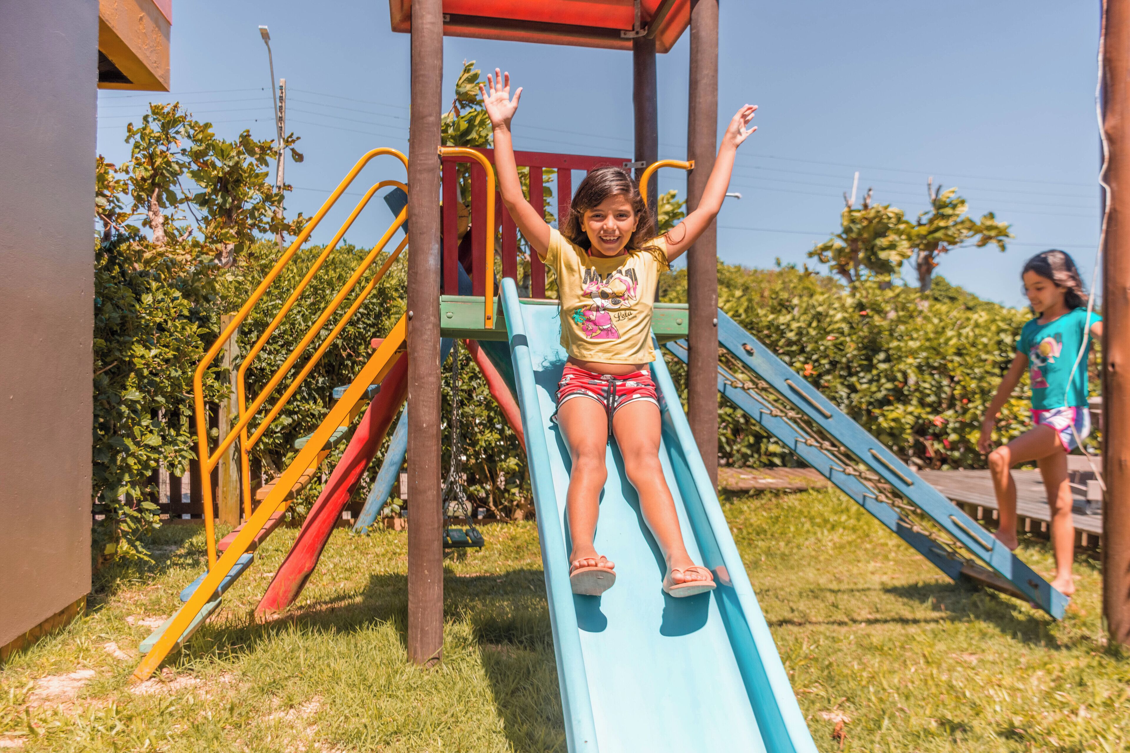 A playground with a blue slide and colorful play structures.