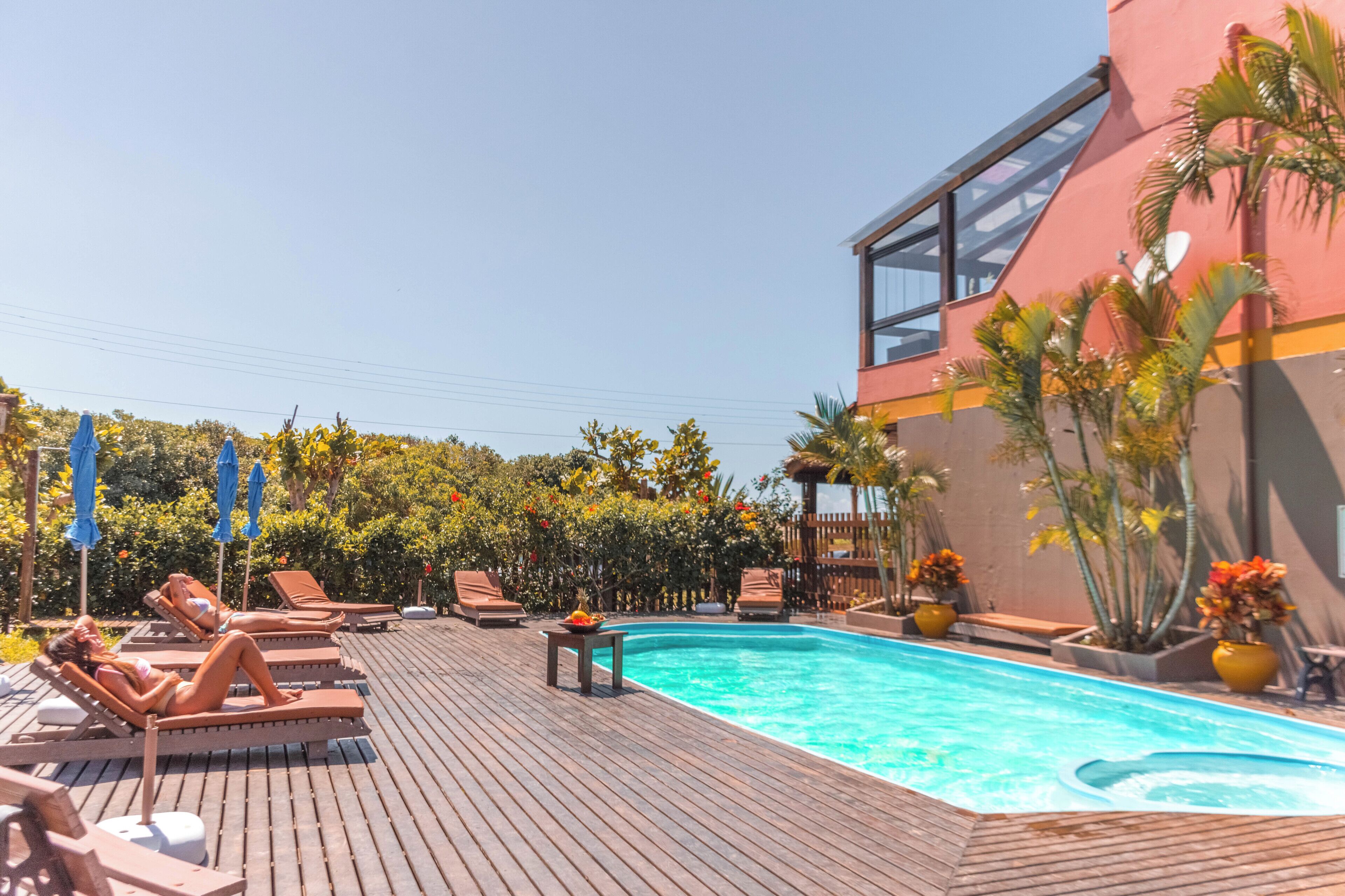 Una piscina al aire libre, sillones reclinables de piscina