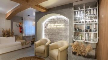 Relax in this stylish living room with a sofa, armchairs, and a round rug.