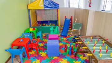 Kids can play and have fun in this play area with a colorful play tent, ball pit, and slide.