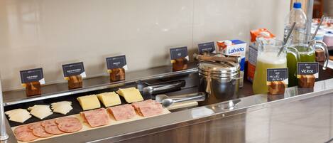 A buffet with various food items and condiments.