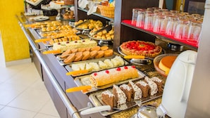 A buffet with various food items and a coffee machine.