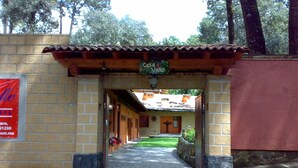 Un sendero de piedra que lleva a un edificio con techo de tejas y un letrero que dice "Casa Valle".