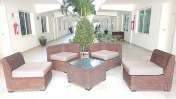 Relax in this inviting space with wicker furniture and a glass-top table.