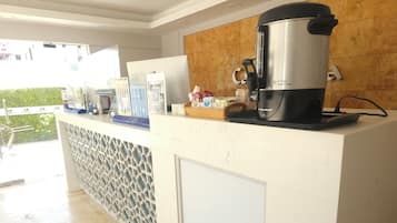 Enjoy cooking and brewing in this fully equipped kitchen area with a coffee maker, kettle, and ample storage.