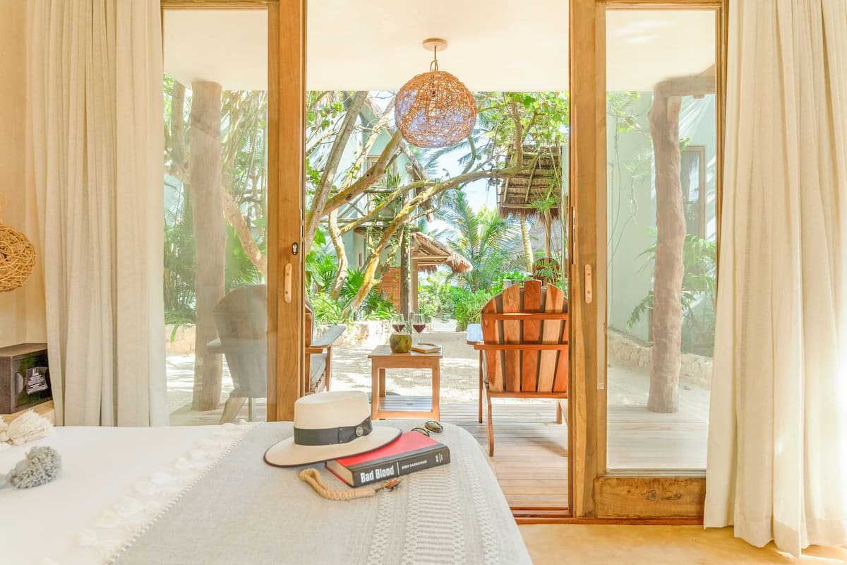 A bedroom with a bed, a hat, and a book.