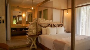 Un dormitorio con cama con dosel, pared de piedra y un espejo grande.