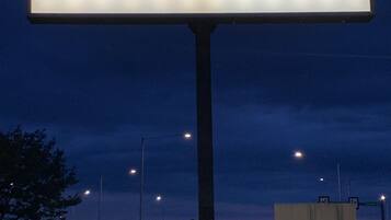 A sign for The Woodlands Inn & Suites.