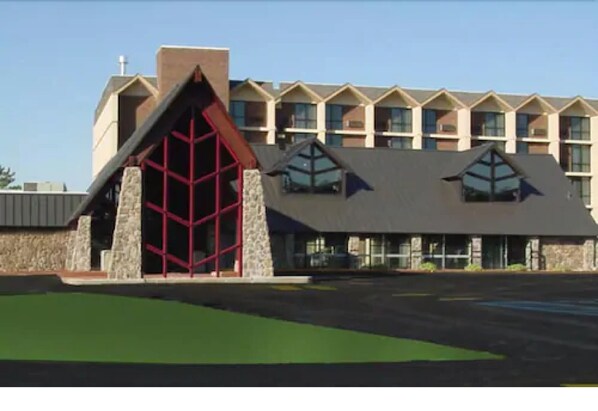 A building with a distinctive red and grey architectural design, featuring a large central entrance and multiple windows.