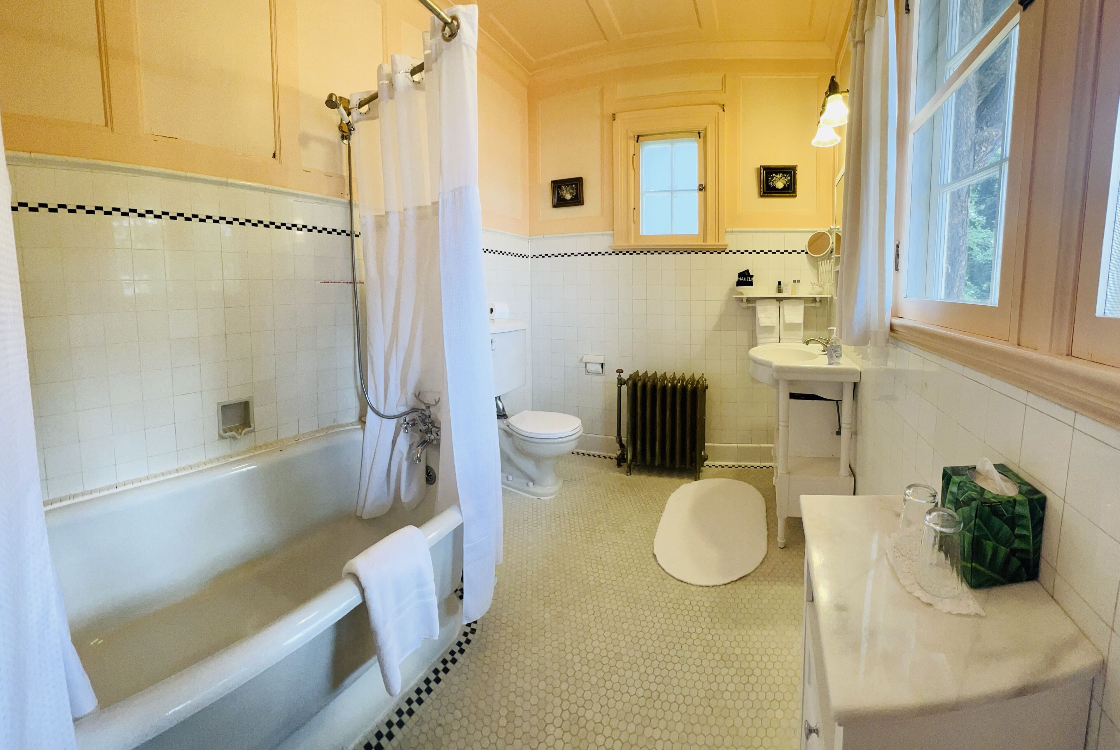 A bathroom with a bathtub, toilet, and sink.