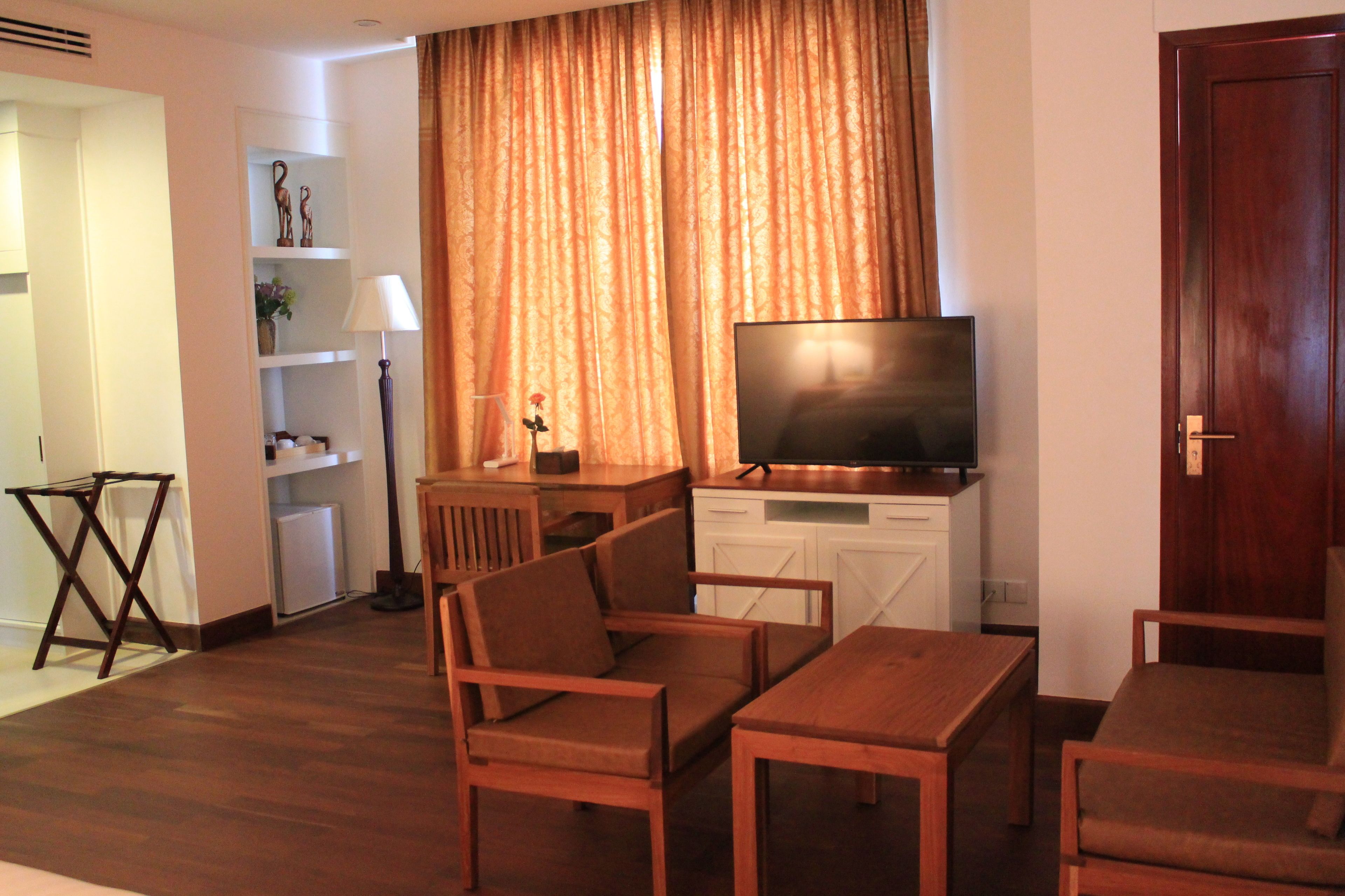 junior suite, 2 single beds, city view | living area | lcd tv, books