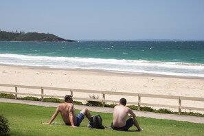 Beach nearby, white sand, beach towels