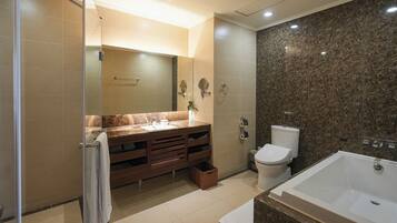 A modern bathroom with a glass shower enclosure, a vanity with a mirror, a toilet, and a bathtub.