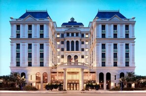 A grand, symmetrical hotel facade with a central entrance, large windows, and a classic architectural style. - Golden Tulip - Aesthetics (Zhunan)