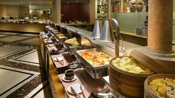 A buffet with various food items and condiments.