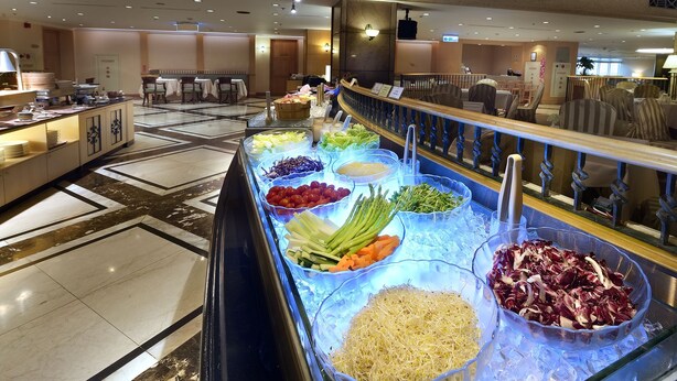 A buffet area with various food options displayed in clear containers.