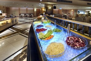 A buffet area with various food options displayed in clear containers.