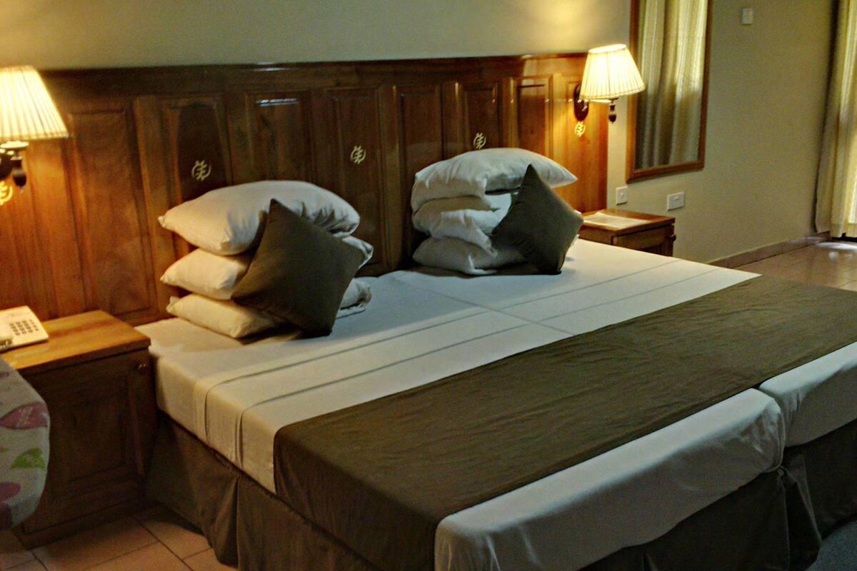 Standard Double Room | Minibar, in-room safe, desk, blackout curtains