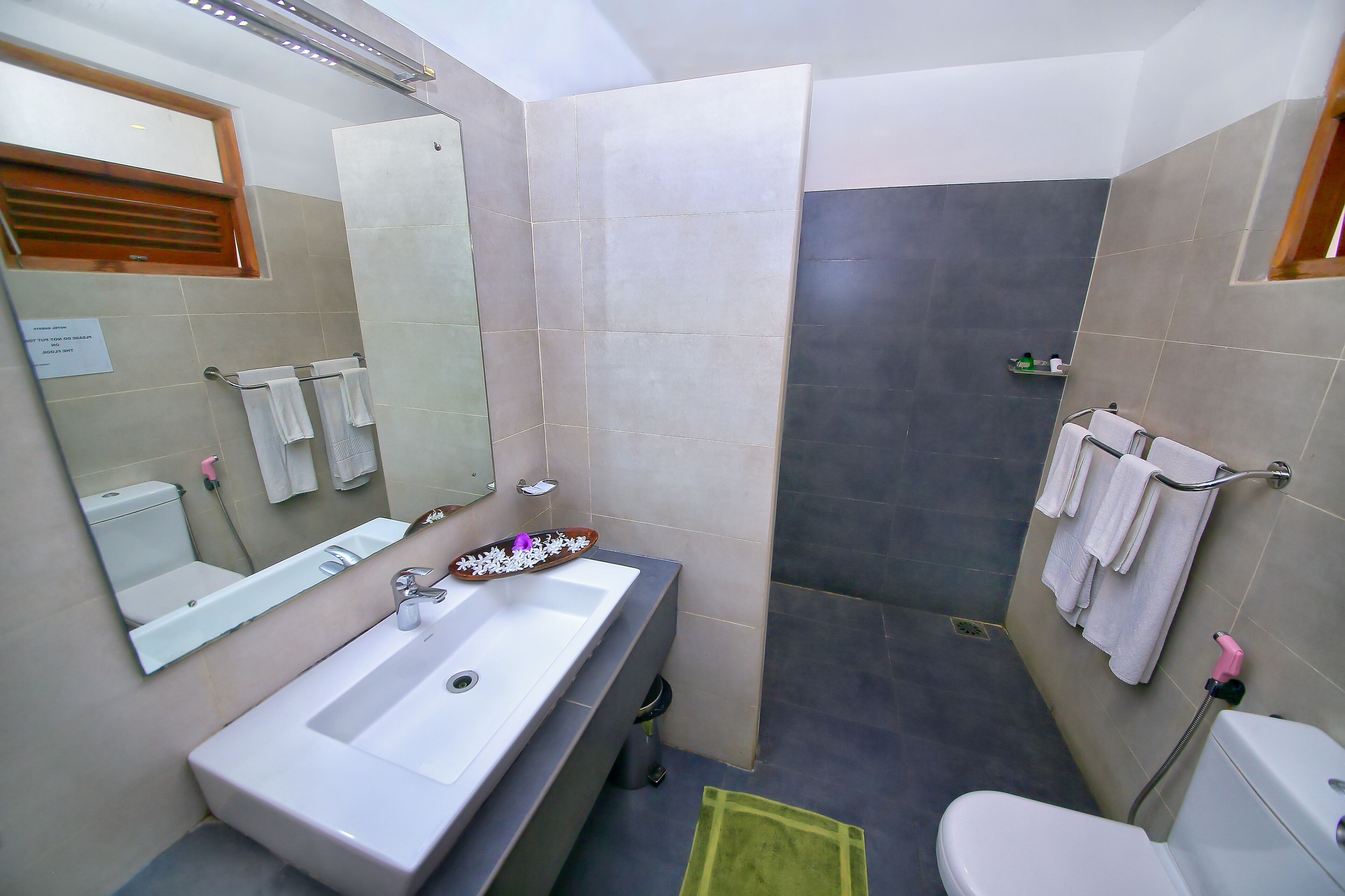 deluxe room | bathroom | shower, rainfall showerhead, free toiletries, hair dryer