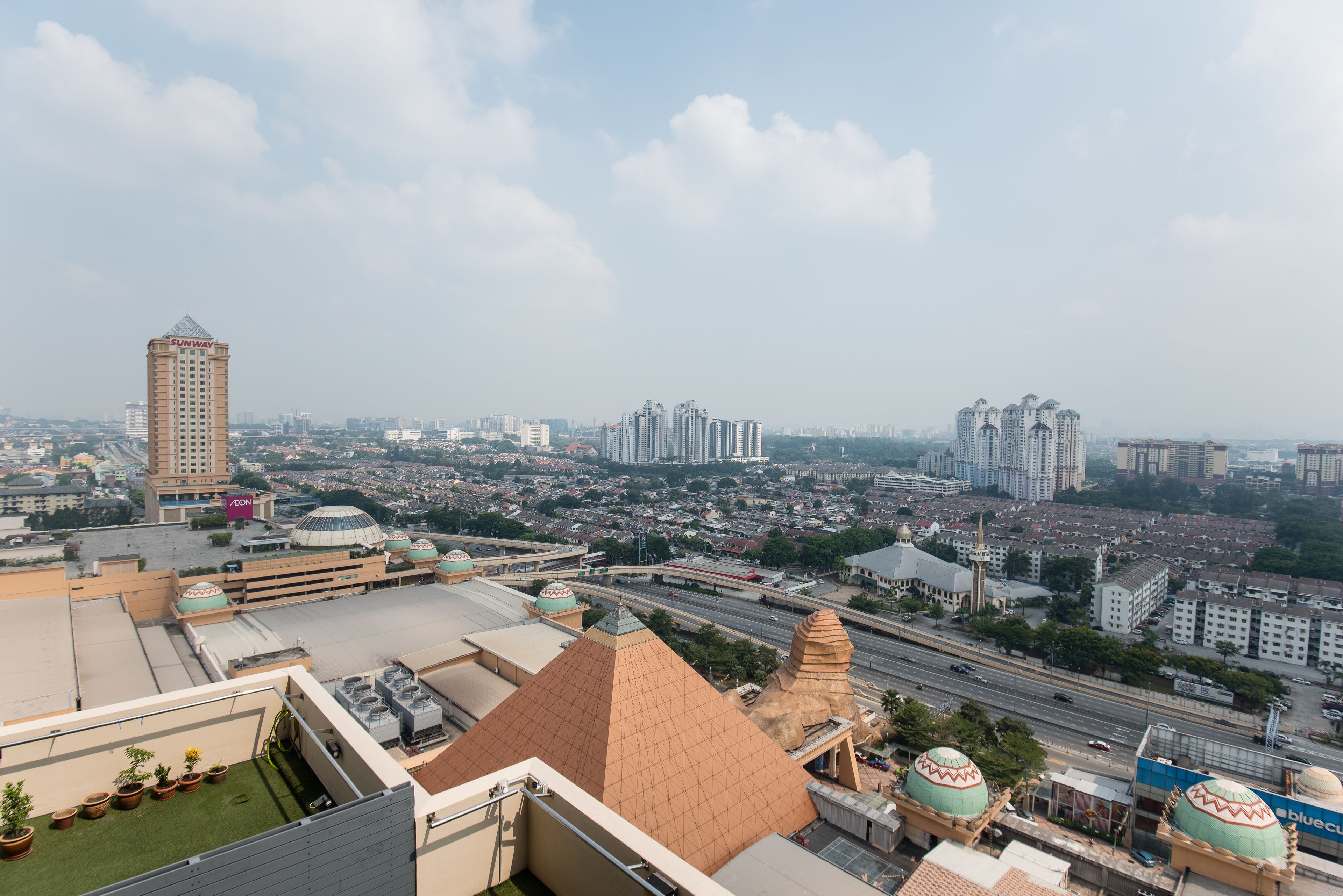 A high-rise building with a dome and a tall tower.