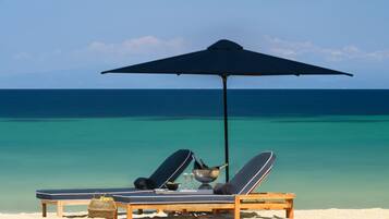 On the beach, sun-loungers, beach umbrellas, beach towels