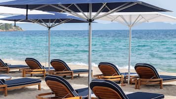 On the beach, sun-loungers, beach umbrellas, beach towels