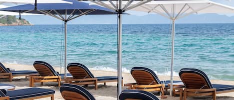 On the beach, sun-loungers, beach umbrellas, beach towels