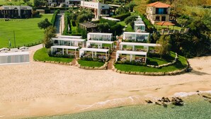 A coastal resort with multiple villas, a sandy beach, and clear turquoise waters. - Avaton Luxury Beach Resort - Relais & Chateaux (Aristotelis)
