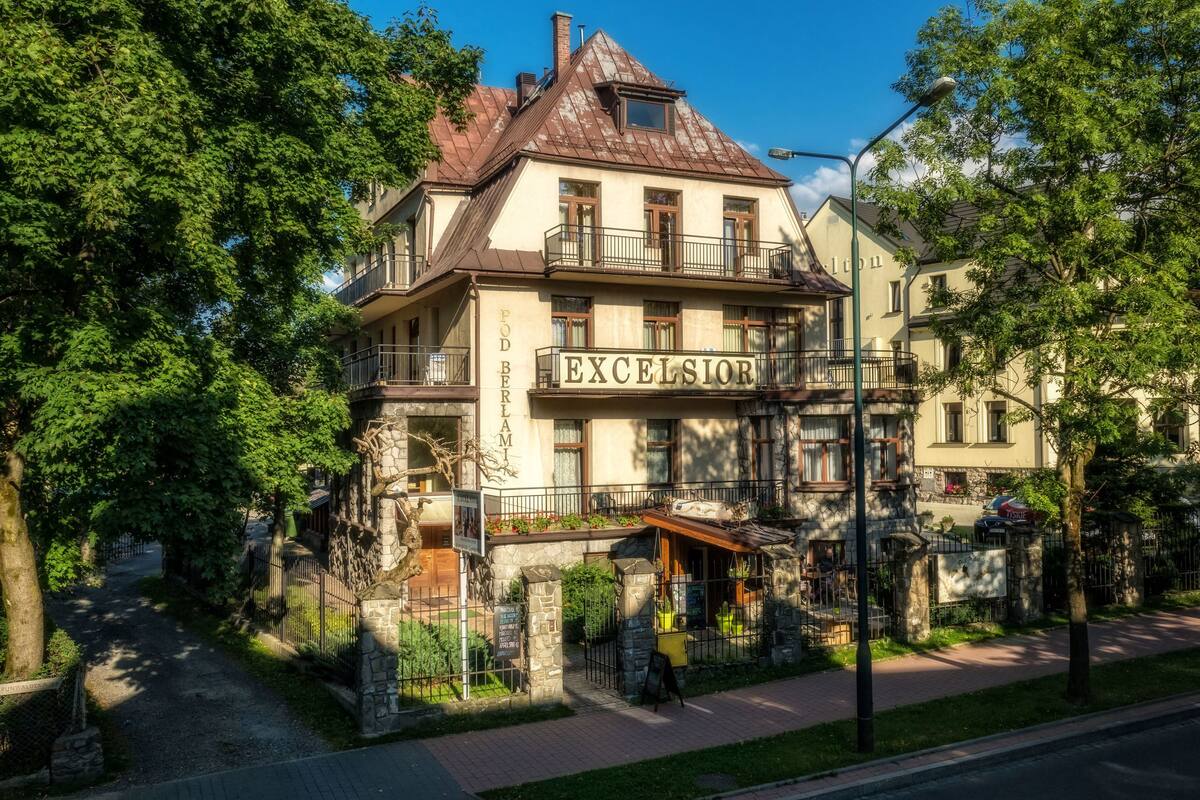 A historic building with a sign reading "EXCELSIOR" and a stone facade.